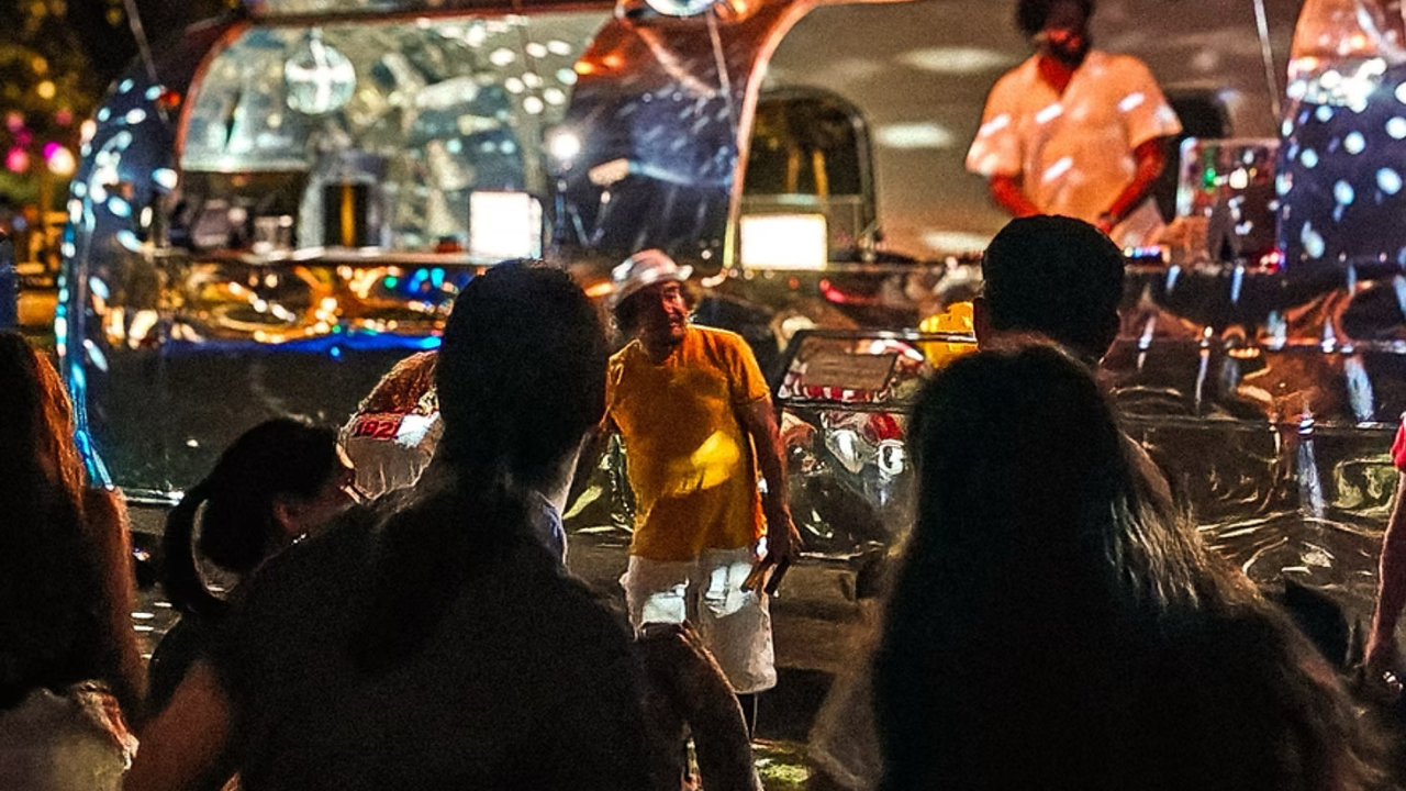 people dancing to dj set in the park