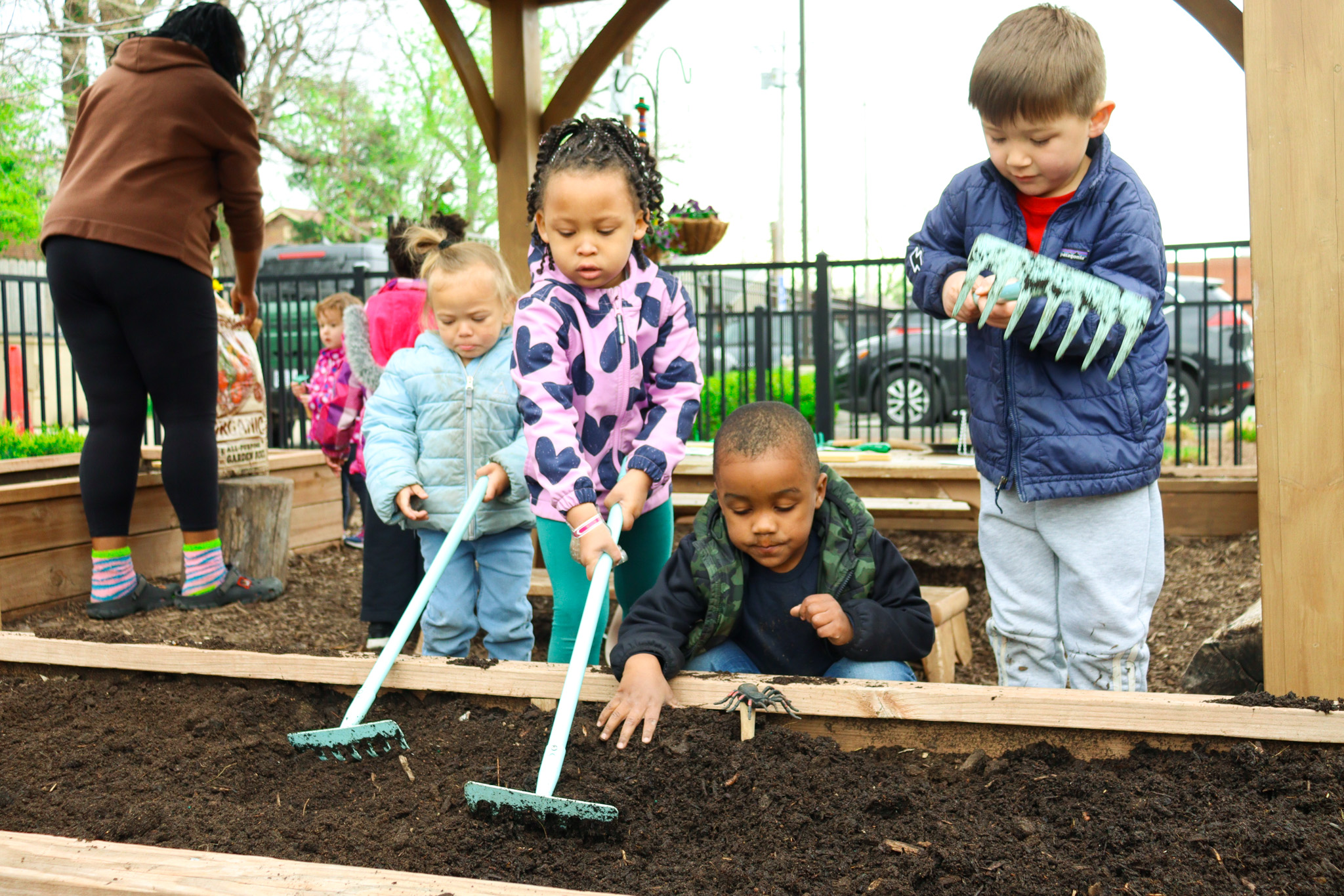Children tending to a raised garden bed