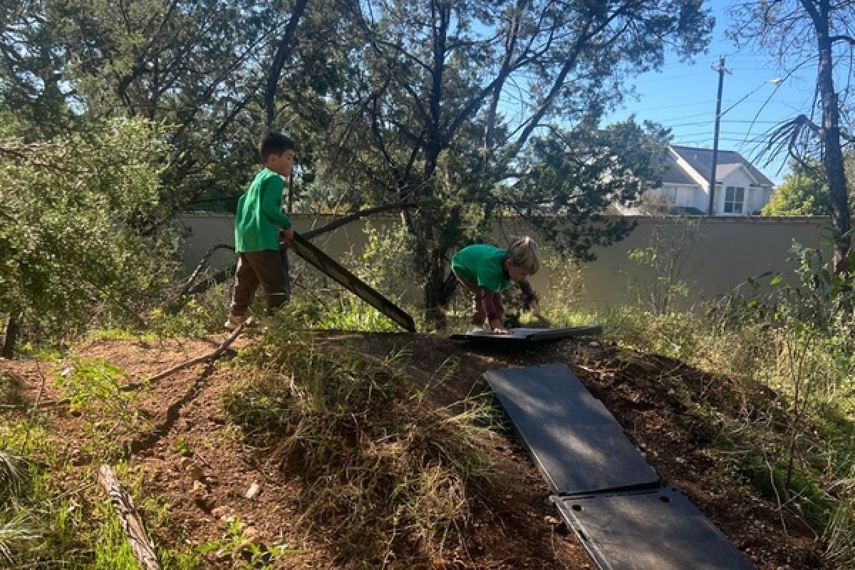 children on top of a slope constructing a ramp